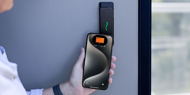 Office staff using employee badge in Apple Wallet to access room