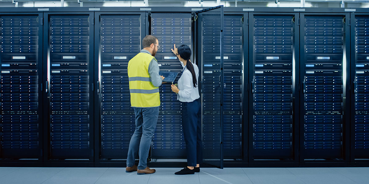 Data center technicians inspecting server rack