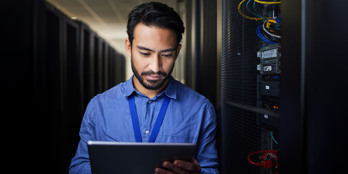 Data center technician working on tablet