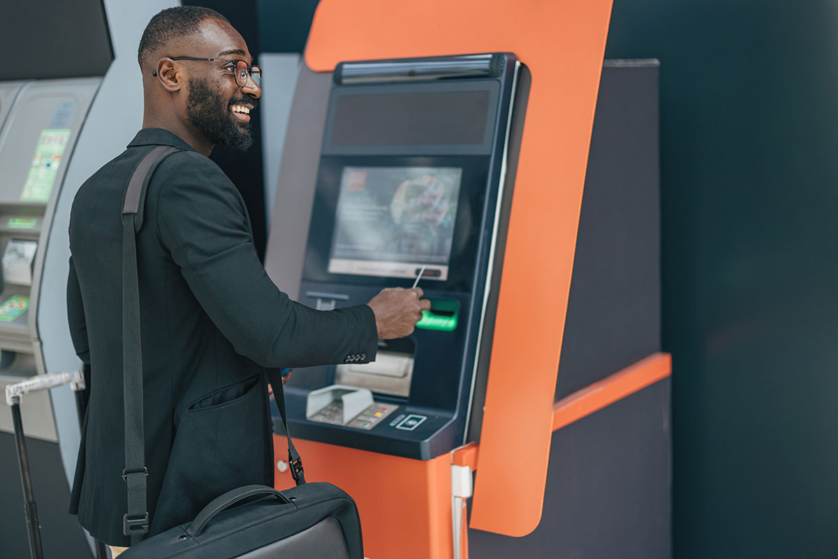 Businessman withdrawing cash at atm