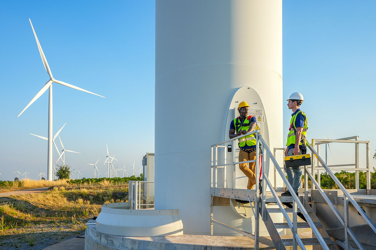 Two electrical engineers implementing access control on wind turbine